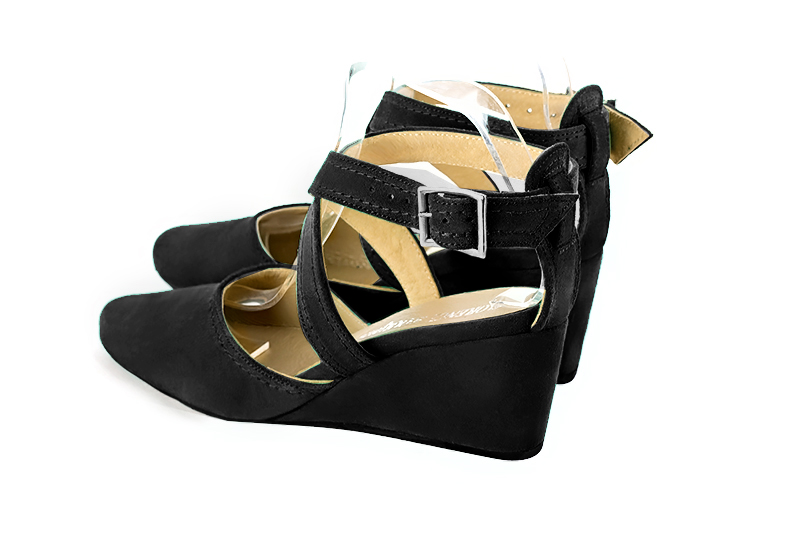Matt black women's open back shoes, with crossed straps. Round toe. Medium wedge heels. Rear view - Florence KOOIJMAN